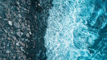 Aerial Photography of waves crashing on a rock beach